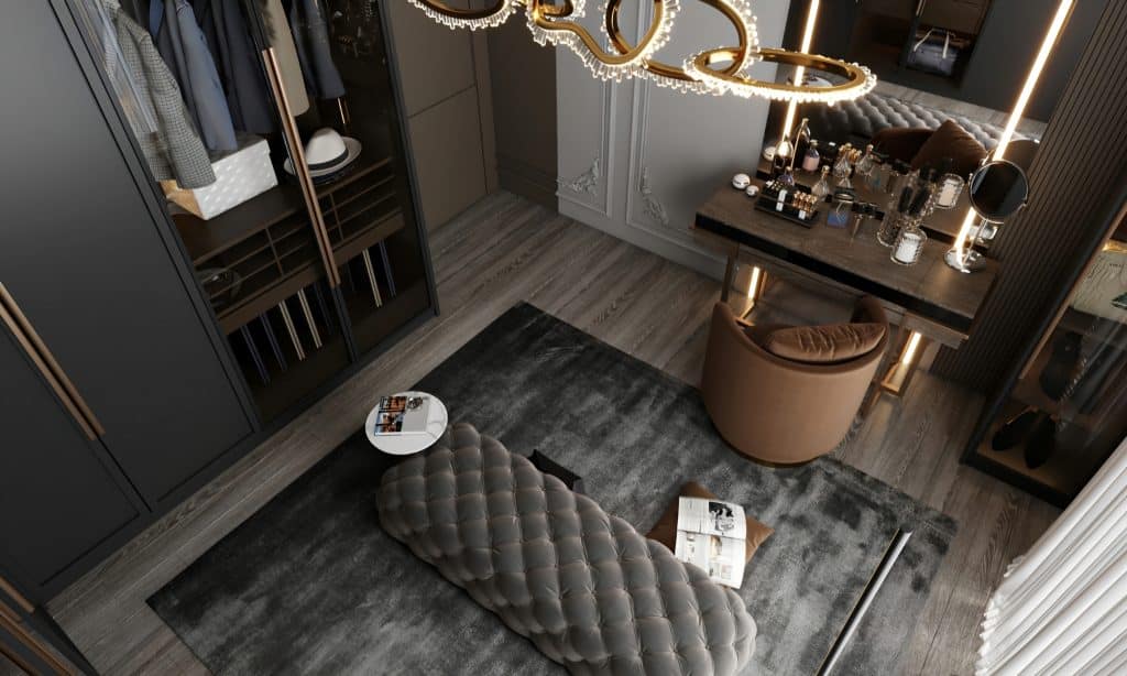 A bespoke walk-in closet in Mr Wardrobe's London residence, complete with a bench and a luxurious chandelier.