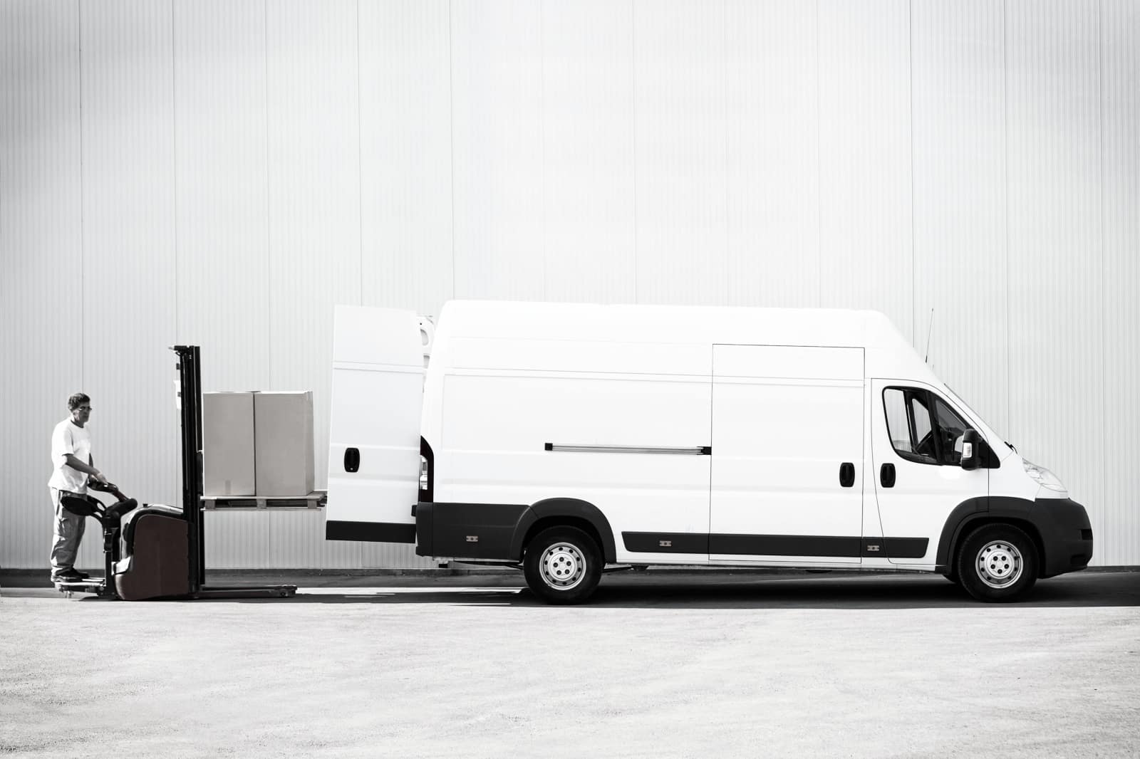 A bespoke white van with Mr Wardrobe standing next to it in London.